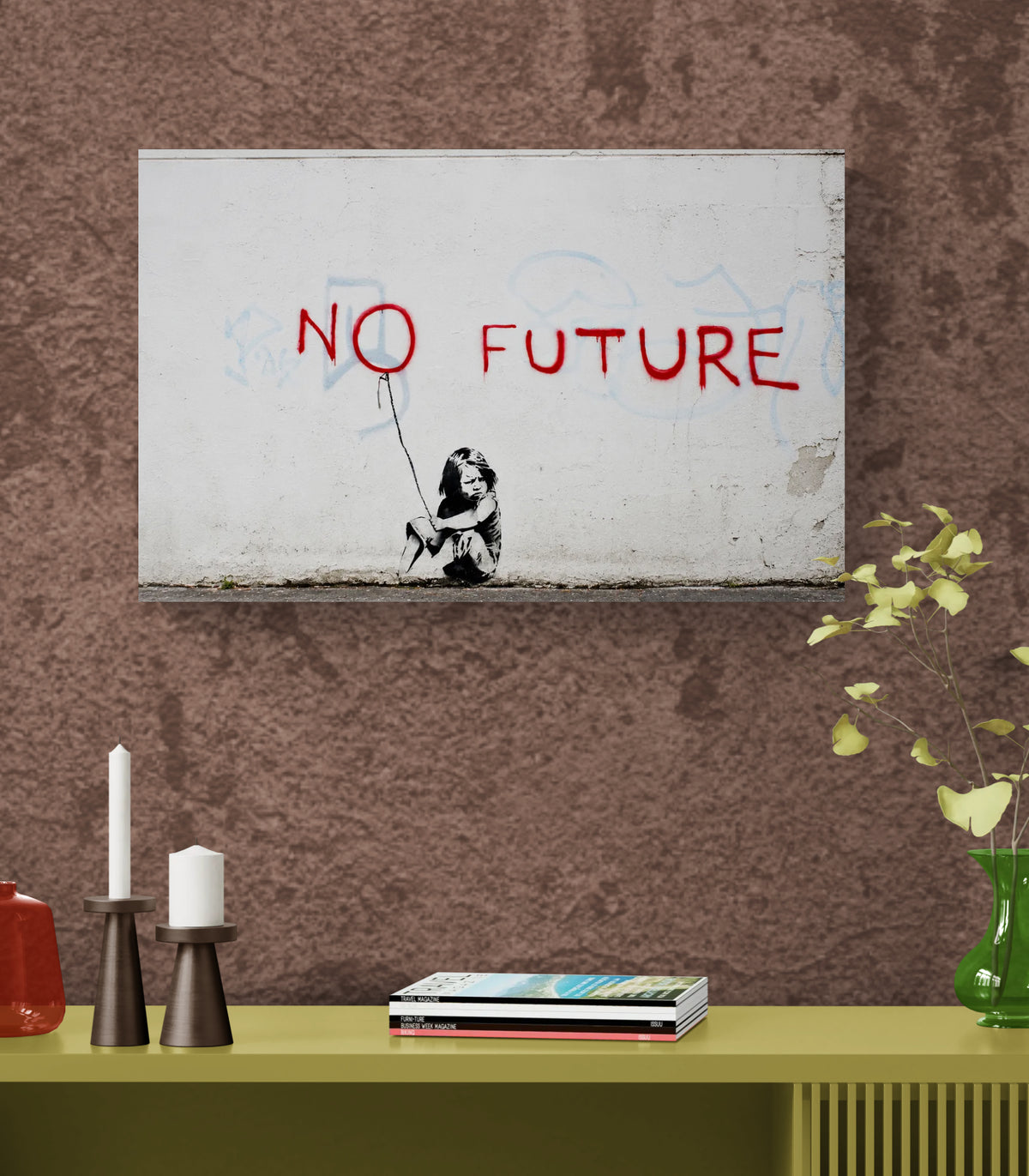 A framed wall art print featuring Banksy's 'No Future' stencil artwork, hanging on a textured brown wall above a yellow-green shelf with decorative items.
